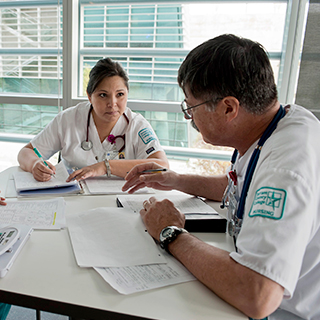 two medical coding students, a man and a woman, studying