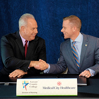 Chancellor Giovanni shaking hands with Medical City Healthcare