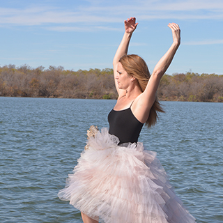 Amy Jennings in a tutu standing in a lake
