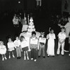 Children representing each year TCJC has been open stand in front of a cake. Click for details