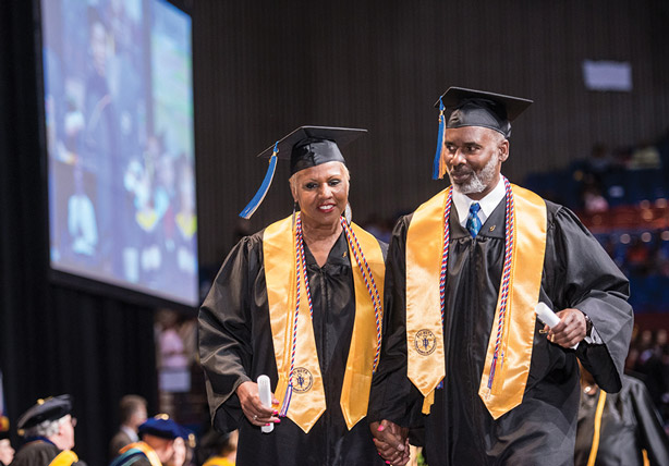 Graduates leaving stage with diplomas