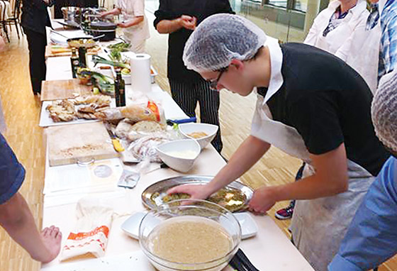 A student plates a dish