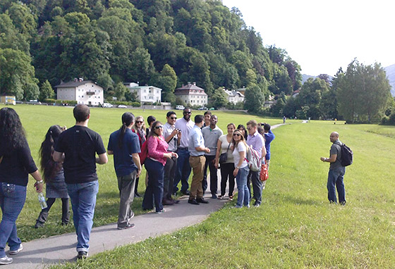 The whole tour group walks along a path together