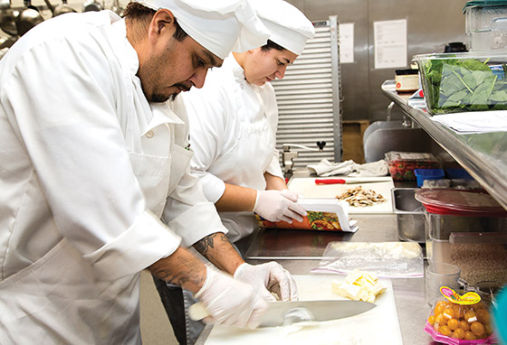 Culinary students prepare ingredients at a counter