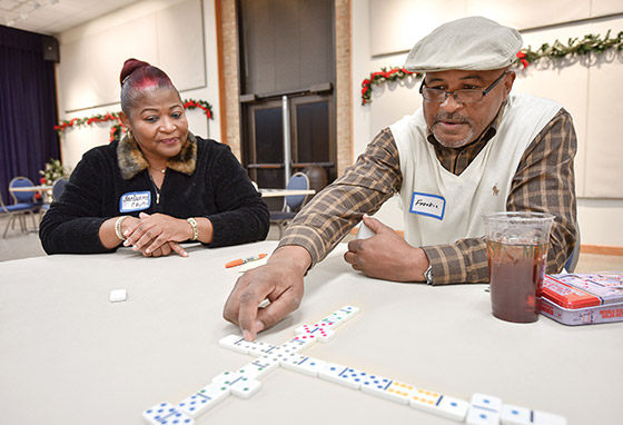 Plus 50 Students play dominoes on Game Club nights