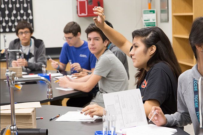 Crystal works with a group of other students in a classroom