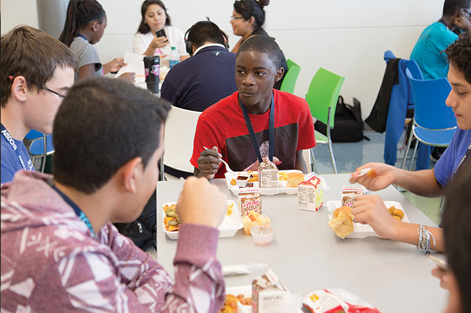 Juarel eats lunch with friends in the cafeteria