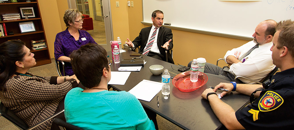 A CARE team sits and brainstorms at a conference table