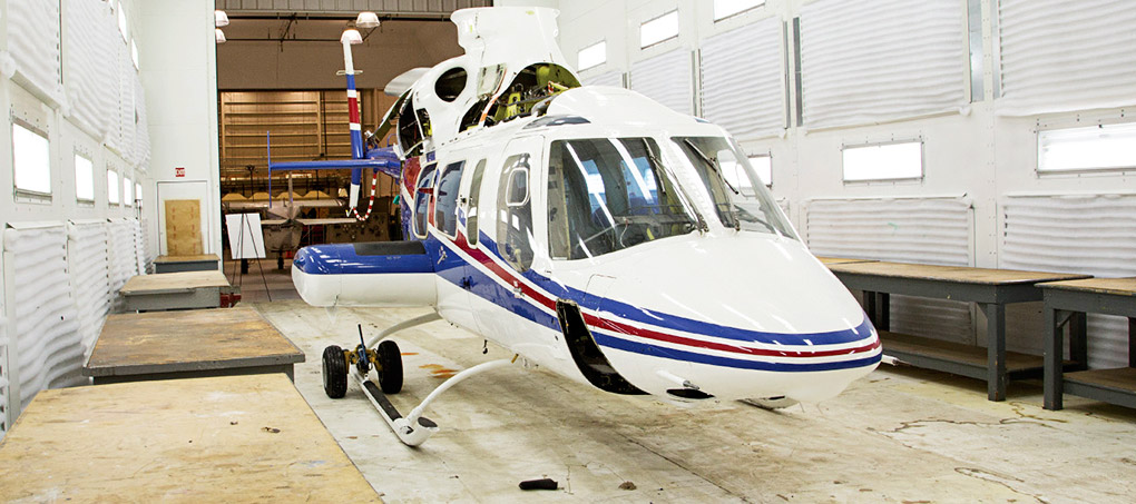 A helicopter awaits in a classroom hangar