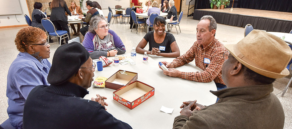 A group of Plus 50 students plays Yahtzee in the cafeteria