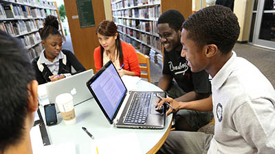A group of students study together in the library