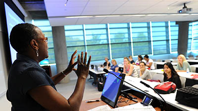 A professor lectures to a class of attentive students