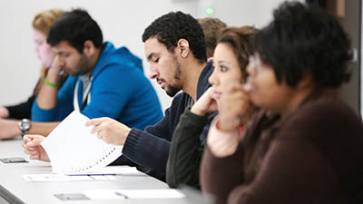 A classroom of students looks over the results of a test