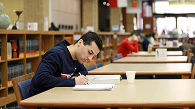 A lone student studies in the library