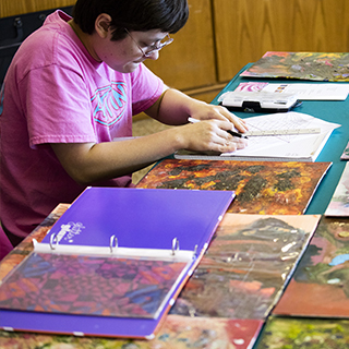 Student drawing on paper with a ruler