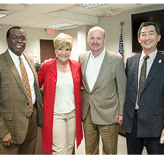 Mayor Betsy Price and TCC representatives holding Blue Zones Project Approved sign