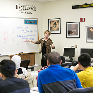 Teacher standing in front of a white board