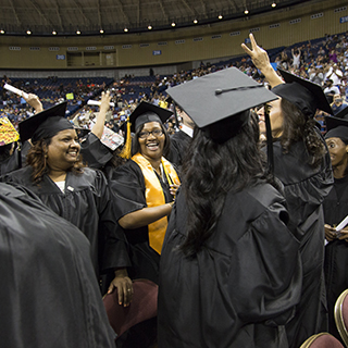 Students standing by their seats during the ceremony