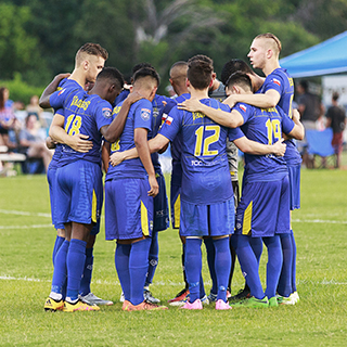 Vaqueros team members in a huddle