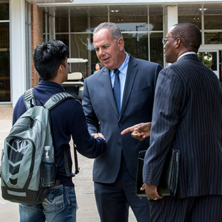 Eugene Giovannini shaking a student's hand