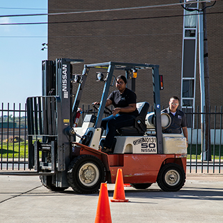 student driving a forklift