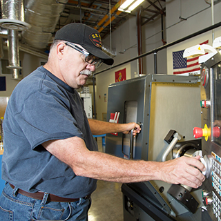 Albert Woolum working on computer numerically controlled (CNC) machinery