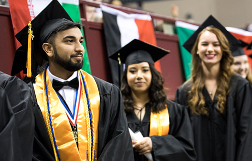 Male student waiting to walk across the stage