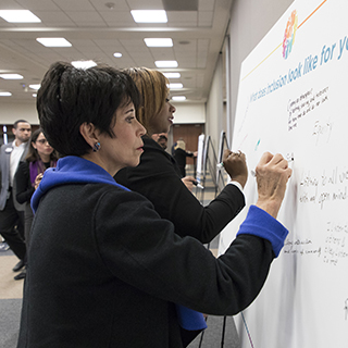 Elva LeBlanc writing on white board