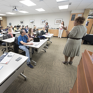 Woman teaching at front of the classroom