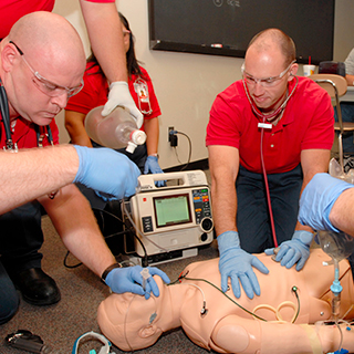 EMT students practicing with simulation manikins