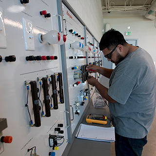 Student at circuits wall