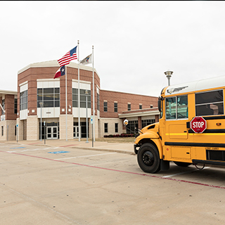 School bus in front of school