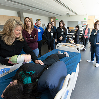 Respiratory therapist students examining a patient