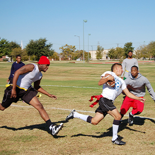 Students running with a football