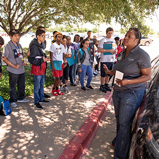 Students listening to an Oncor representative