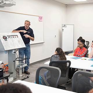 Instructor teaching at the front of a classroom