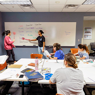 Student teaching at a whiteboard