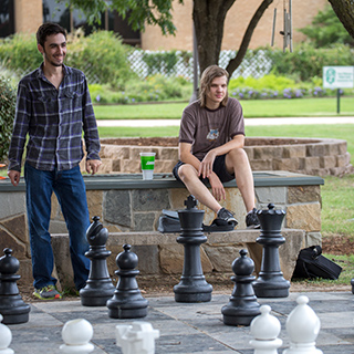 Students playing giant chess