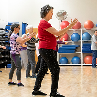 a group of females participating in a tai chi class