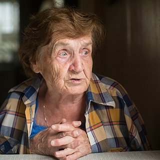 a auburn-haired woman telling a story, her eyes looking to her left