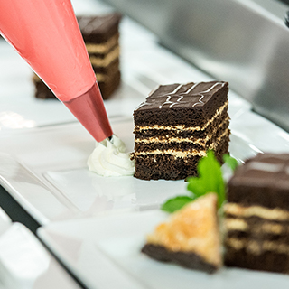 Decorating dessert with a piping bag