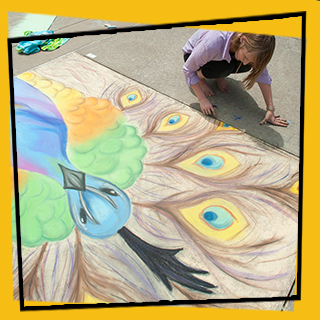 student drawing a peacock with chalk