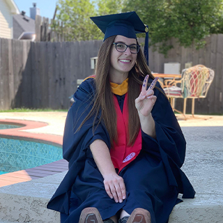 Girl posing in graduation regalia