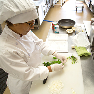 Chef chopping herbs