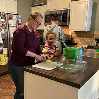 Gabby Hall making food for her daughter