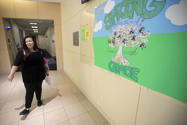 Katie walking down a hallway on Trinity River Campus