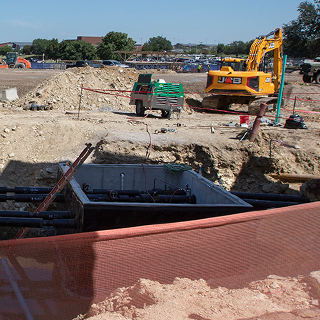 Digger and generator sitting out in the construction area