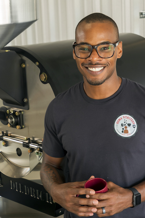 Justin McLaughlin standing in front of a coffee roaster