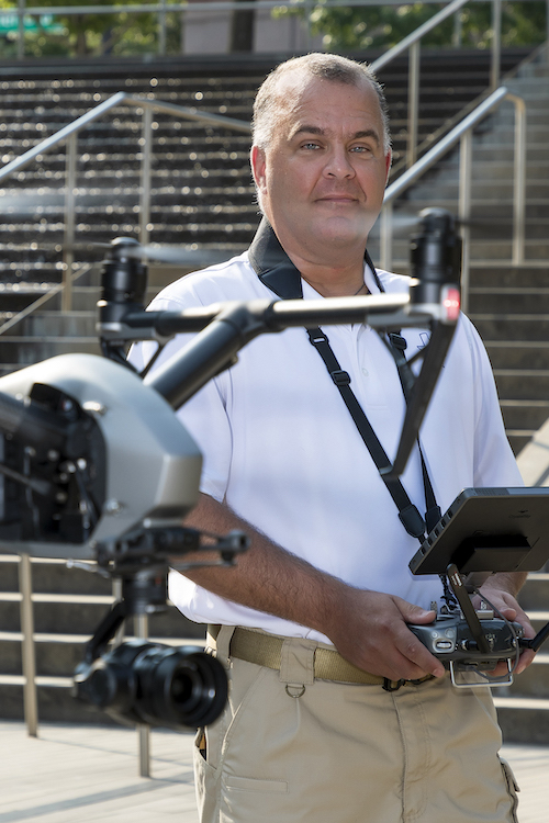 Philip Viola pilots a drone that hovers in front of him