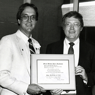 Archive photo of excellence award winners showing certificate